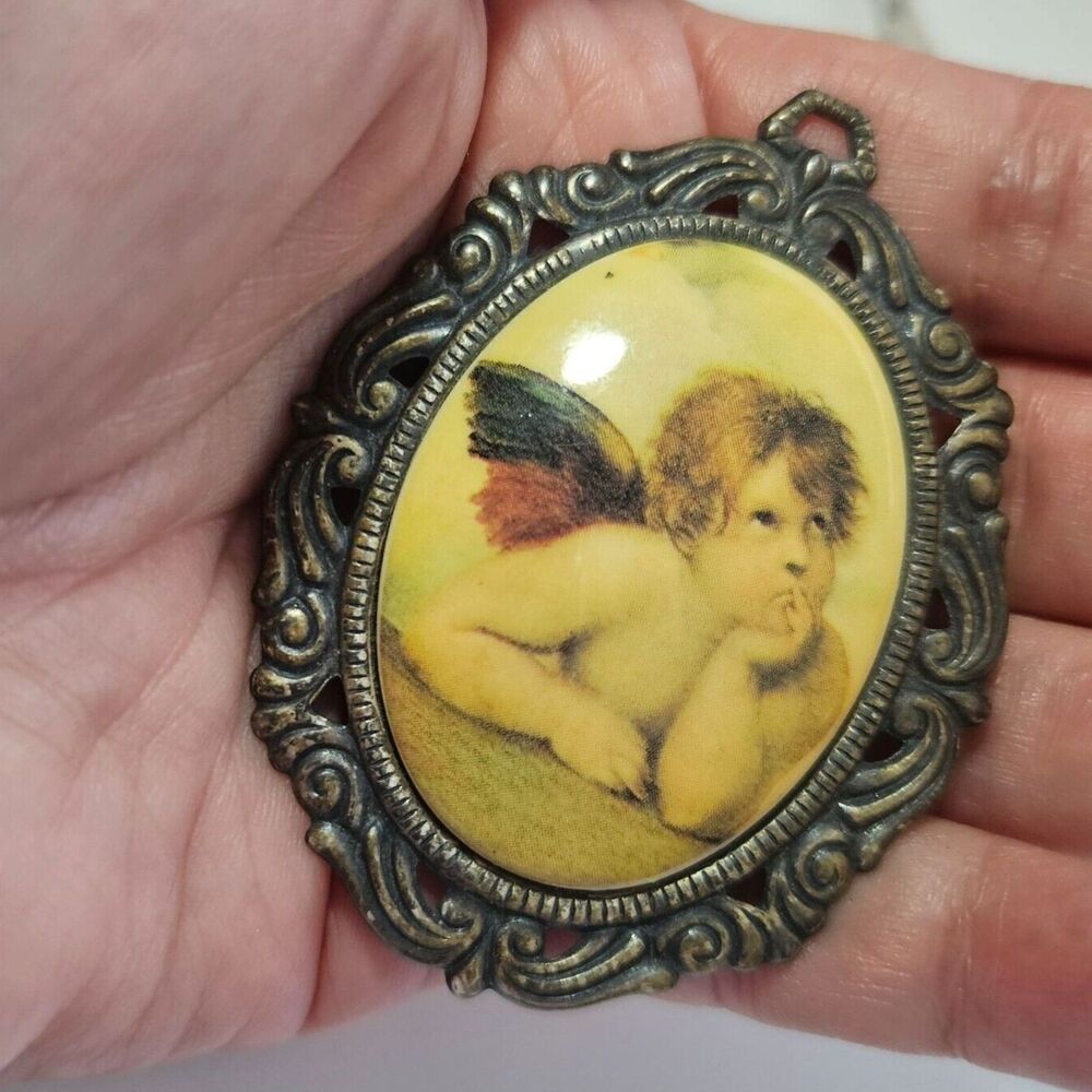 Silver tone vintage oval angel in thought brooch